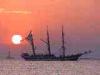 Baia Verde fraction of Gallipoli (Lecce, Italy): Sunset with ship and Sant'Andrea Island