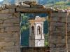 Forgnengo fraction of Campiglia Cervo (Biella, Italy): Bell tower of the church from behind a stone wall